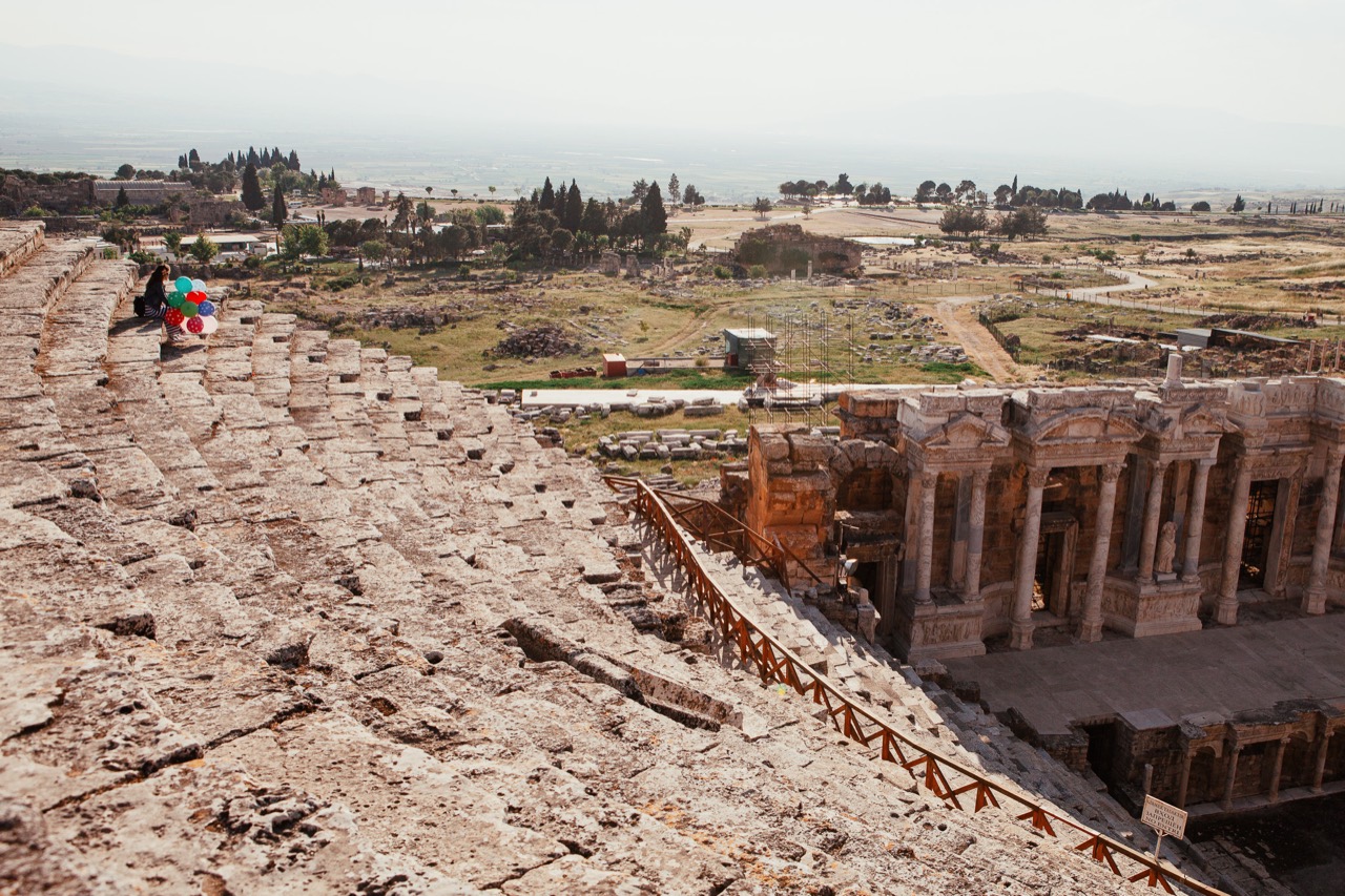 Visitors walking among ancient stone ruins and excavated foundations