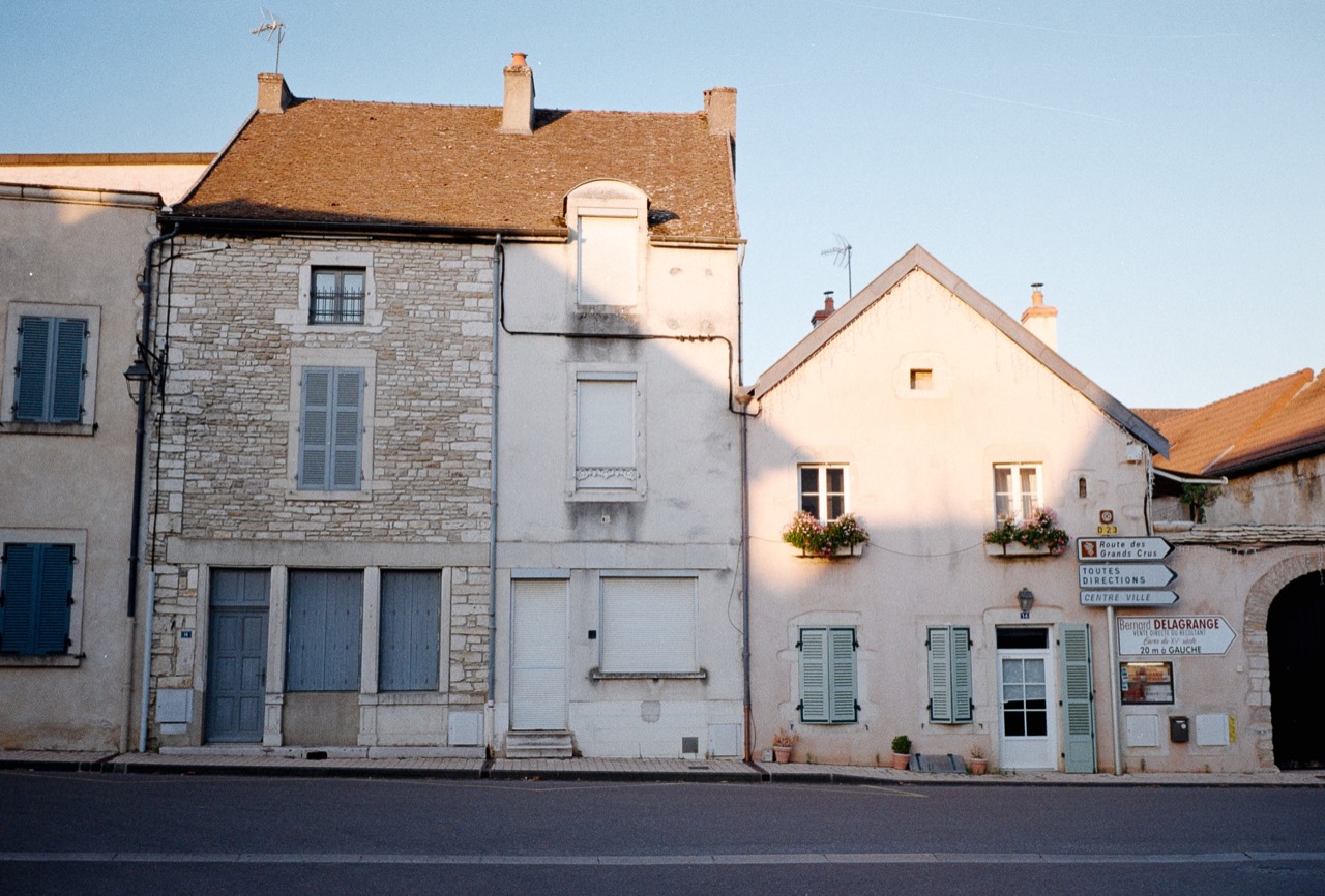 Pale village houses with tiled roofs and shuttered windows